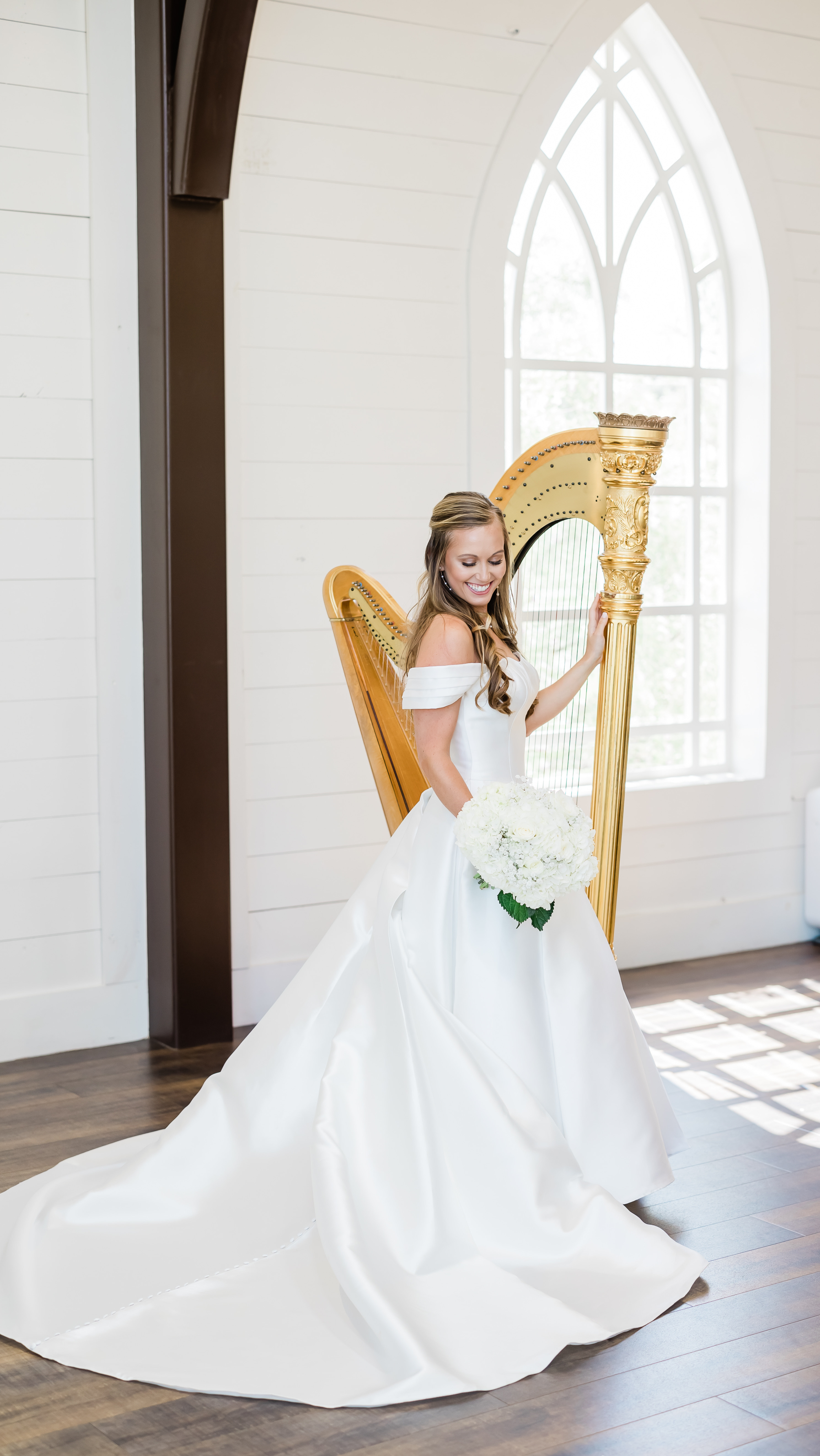 Grace with her harp by an arched window