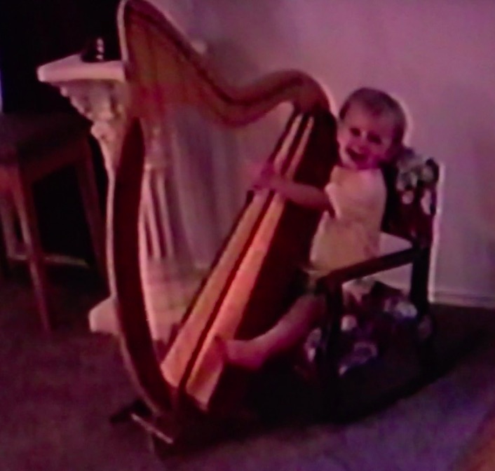 Young Grace playing the harp with joy - Austin harpist's early years